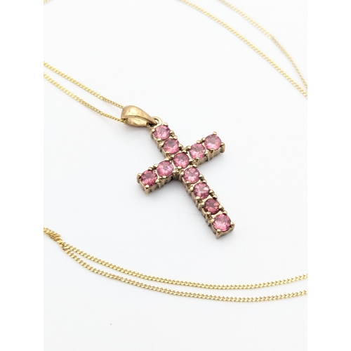 46 - A 9ct yellow gold and pink tourmaline cross pendant on a 9ct gold fine necklace with spring ring cla... 