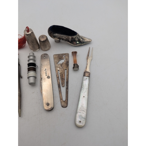 5 - Silver collectables to include a bobbin case, a pincushion fashioned as a shoe, fruit knife and othe... 