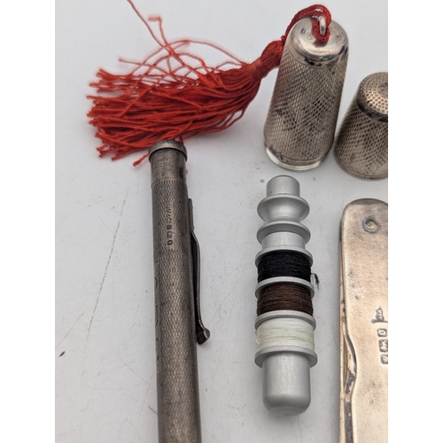 5 - Silver collectables to include a bobbin case, a pincushion fashioned as a shoe, fruit knife and othe... 