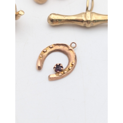 50 - Seven 9ct yellow gold charms comprising of three rings, two ballet shoes, a high heel, teapot and mu... 