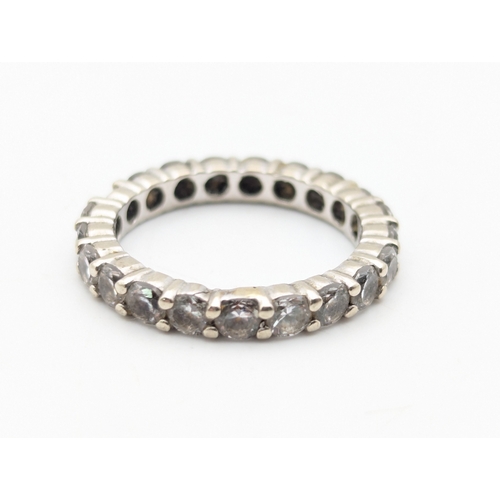 58 - A 14ct white gold and tourmaline full eternity ring (some stones chipped) size L1/2, weight 3.3g
Loc... 