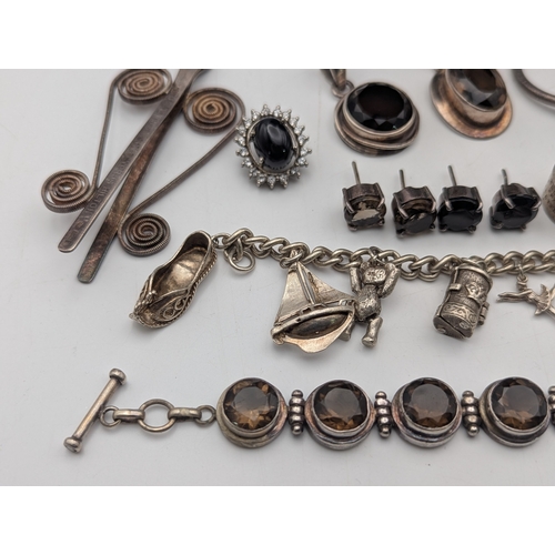 59 - Silver and white metal jewellery to include a sterling silver charm bracelet with an assortment of c... 