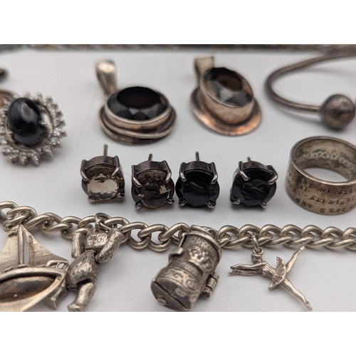 59 - Silver and white metal jewellery to include a sterling silver charm bracelet with an assortment of c... 