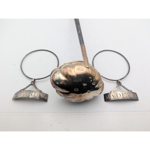 6 - Silver to include two decanter labels Sherry and Madeira, total weight 31.3g together with a toddy l... 