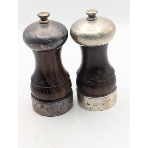 8 - A pair of silver topped and collared salt and pepper grinders by David R Mills 
Location:A3B
If ther... 