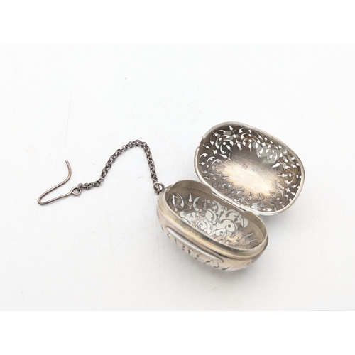 9 - A Victorian silver tea infuser having repeated pierced design by Brownett and Rose hallmarked London... 