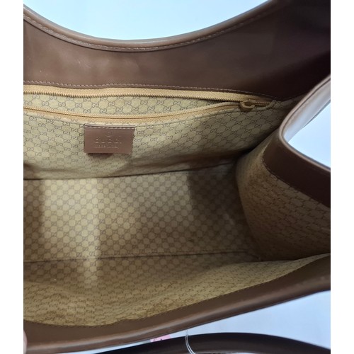 3 - Gucci- A brown Jackie Bardot leather shoulder bag having silver tone hardware, double handles, fabri... 