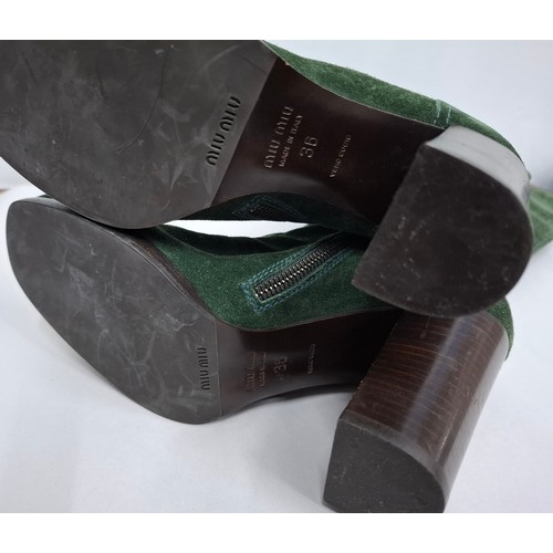 4 - Miu Miu- A pair of green suede lace up boots having a 3.5