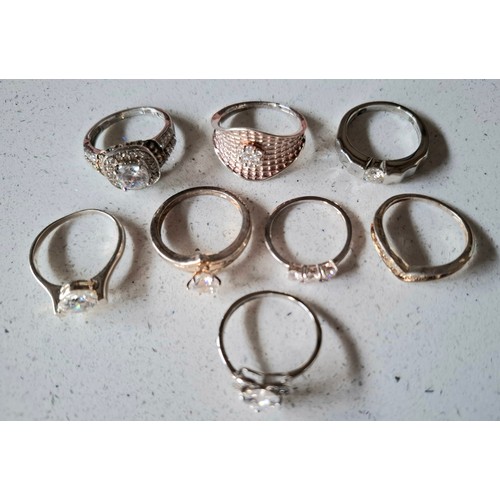 56 - A group of 8 silver rings to include one set with small diamonds and 5 with cubic zirconias, total w... 