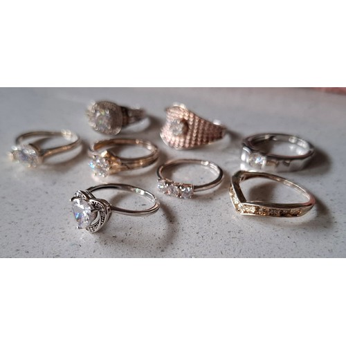 56 - A group of 8 silver rings to include one set with small diamonds and 5 with cubic zirconias, total w... 