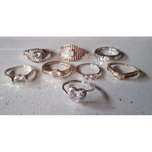 56 - A group of 8 silver rings to include one set with small diamonds and 5 with cubic zirconias, total w... 