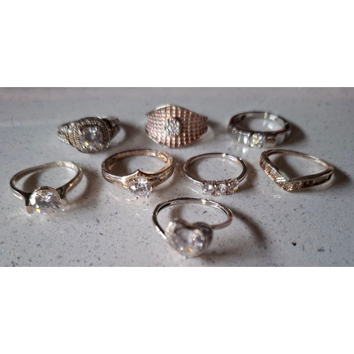 56 - A group of 8 silver rings to include one set with small diamonds and 5 with cubic zirconias, total w... 