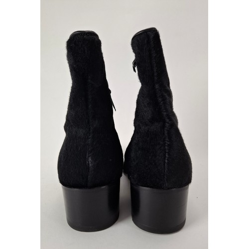 9 - Gucci- A pair of unworn gents black hide ankle boots 'Nero 19' having a side zipper with leather tog... 
