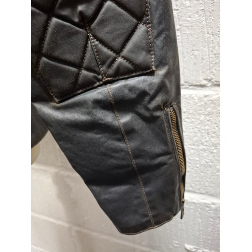 26 - Belstaff- A gents dark brown wax cotton biker style jacket having a tartan lining and black cord col... 