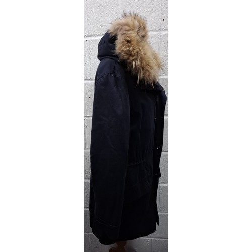 27 - Yves Salomon- A gents navy hooded parka coat having a detachable brown rabbit fur lining and coyote ... 