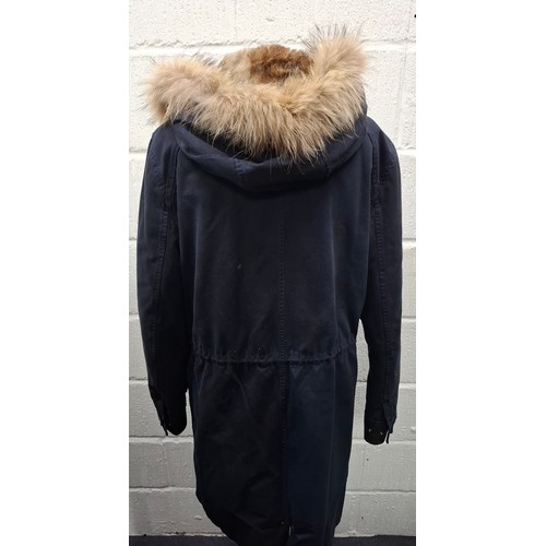 27 - Yves Salomon- A gents navy hooded parka coat having a detachable brown rabbit fur lining and coyote ... 