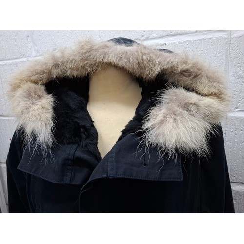 29 - Yves Salomon- An unworn black cotton parka coat having a detachable black rabbit fur lining and coyo... 