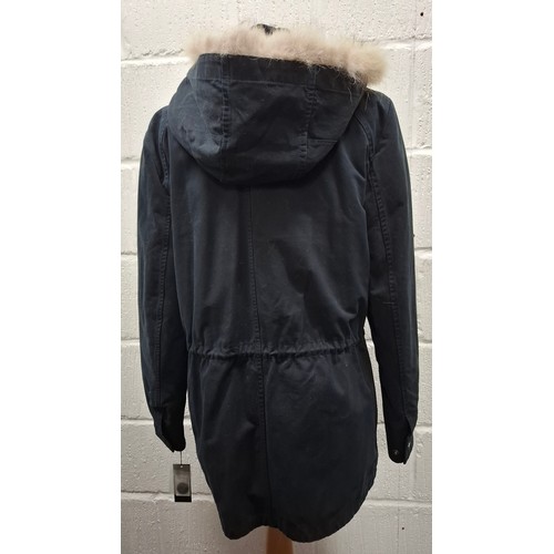 29 - Yves Salomon- An unworn black cotton parka coat having a detachable black rabbit fur lining and coyo... 