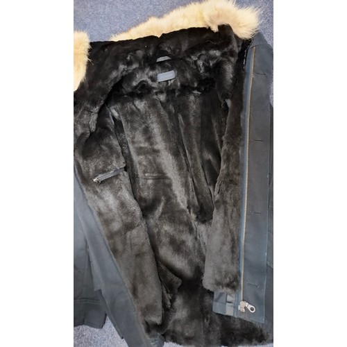 29 - Yves Salomon- An unworn black cotton parka coat having a detachable black rabbit fur lining and coyo... 