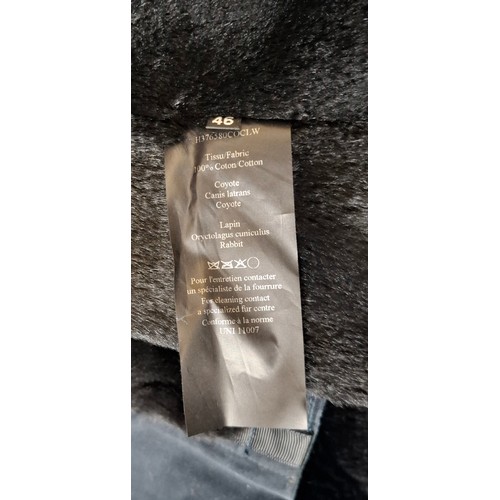 29 - Yves Salomon- An unworn black cotton parka coat having a detachable black rabbit fur lining and coyo... 