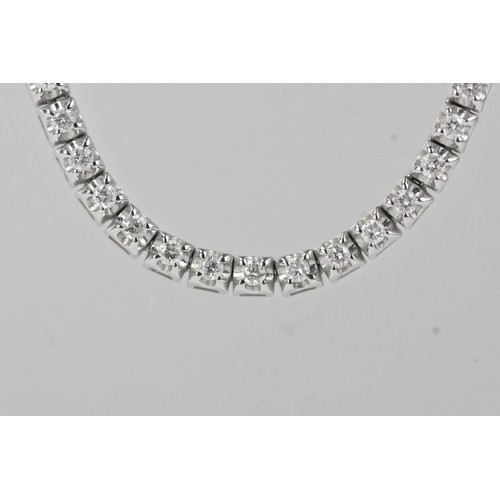 14 - An 18ct white gold diamond line necklace, of classic tennis design, set throughout with a continuous... 
