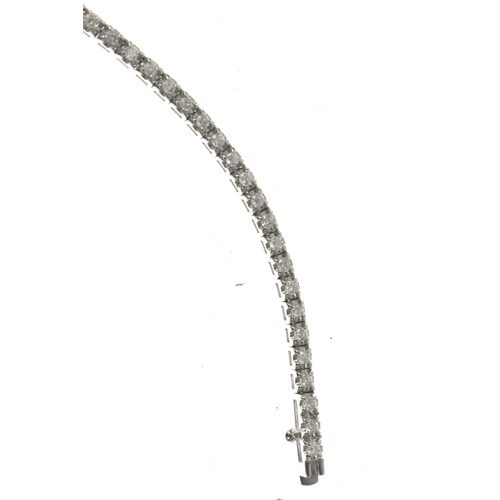 14 - An 18ct white gold diamond line necklace, of classic tennis design, set throughout with a continuous... 