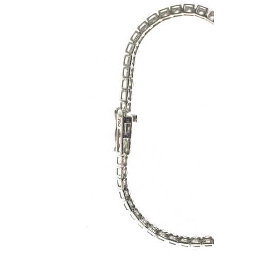 14 - An 18ct white gold diamond line necklace, of classic tennis design, set throughout with a continuous... 