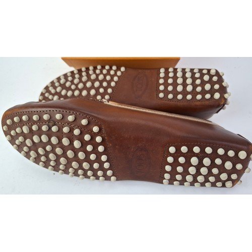 14 - Tod's- A pair of ladies Gommini moccasins in dark brown with silver accents, European size 38 having... 