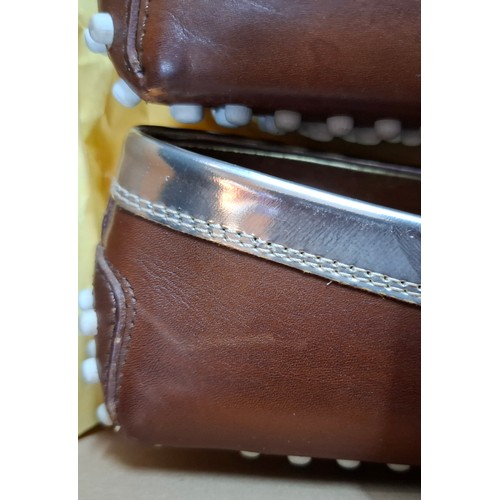 14 - Tod's- A pair of ladies Gommini moccasins in dark brown with silver accents, European size 38 having... 