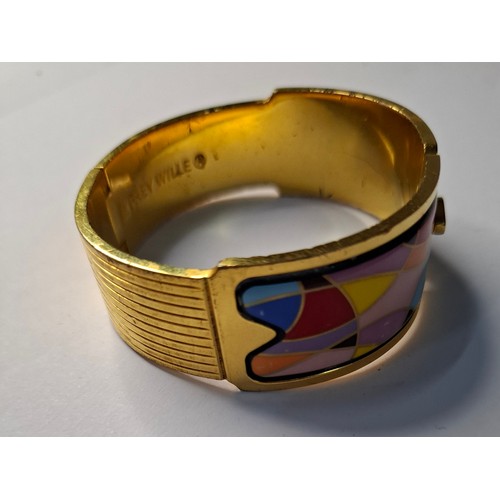 47 - Frey Wille- A gilt metal and enamel hinged bangle with harlequin design in various colours, to fit m... 
