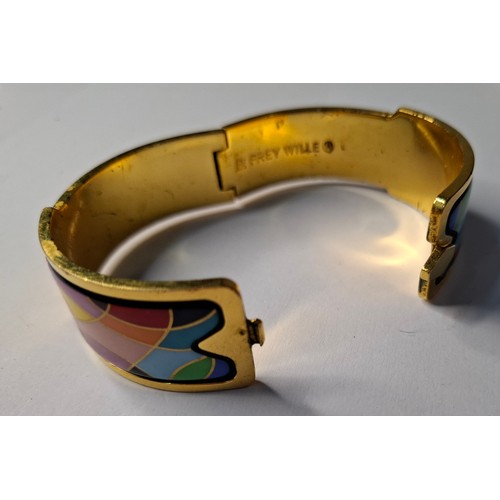 47 - Frey Wille- A gilt metal and enamel hinged bangle with harlequin design in various colours, to fit m... 