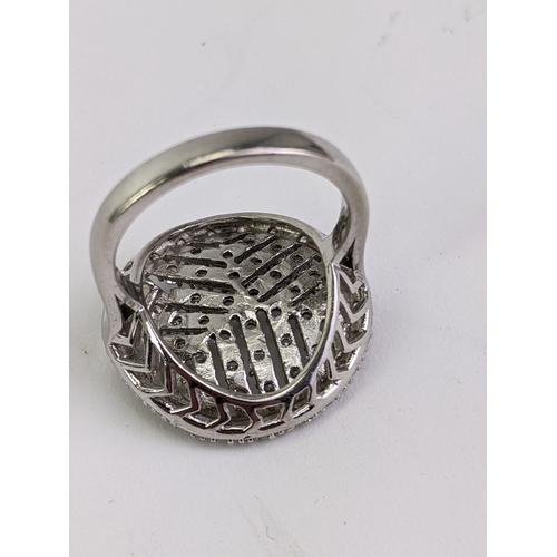 32 - A silver ring set with Diamonique cubic zirconia, in a circular setting
Location:C2
If there is no c... 