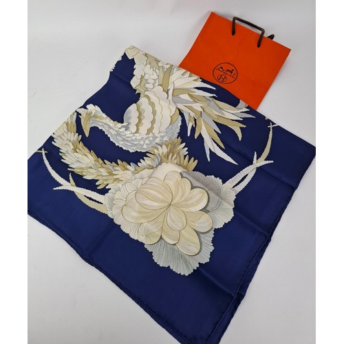 15 - Hermes- A 1990's Tahiti by Cathy Latham silk scarf having a navy ground with gold, cream and grey fl... 