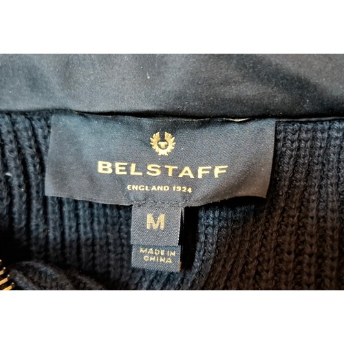 19 - Belstaff- A gents black casual jacket having knitted sleeves and back and a padded, waterproof front... 