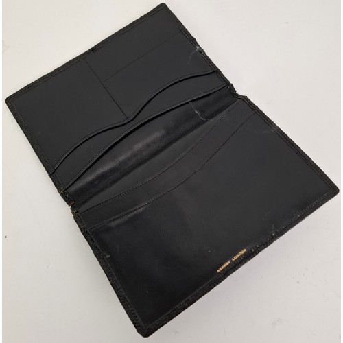 17 - Asprey- A pre-1970's black leather snakeskin wallet with the initials NSG within a circle in yellow ... 