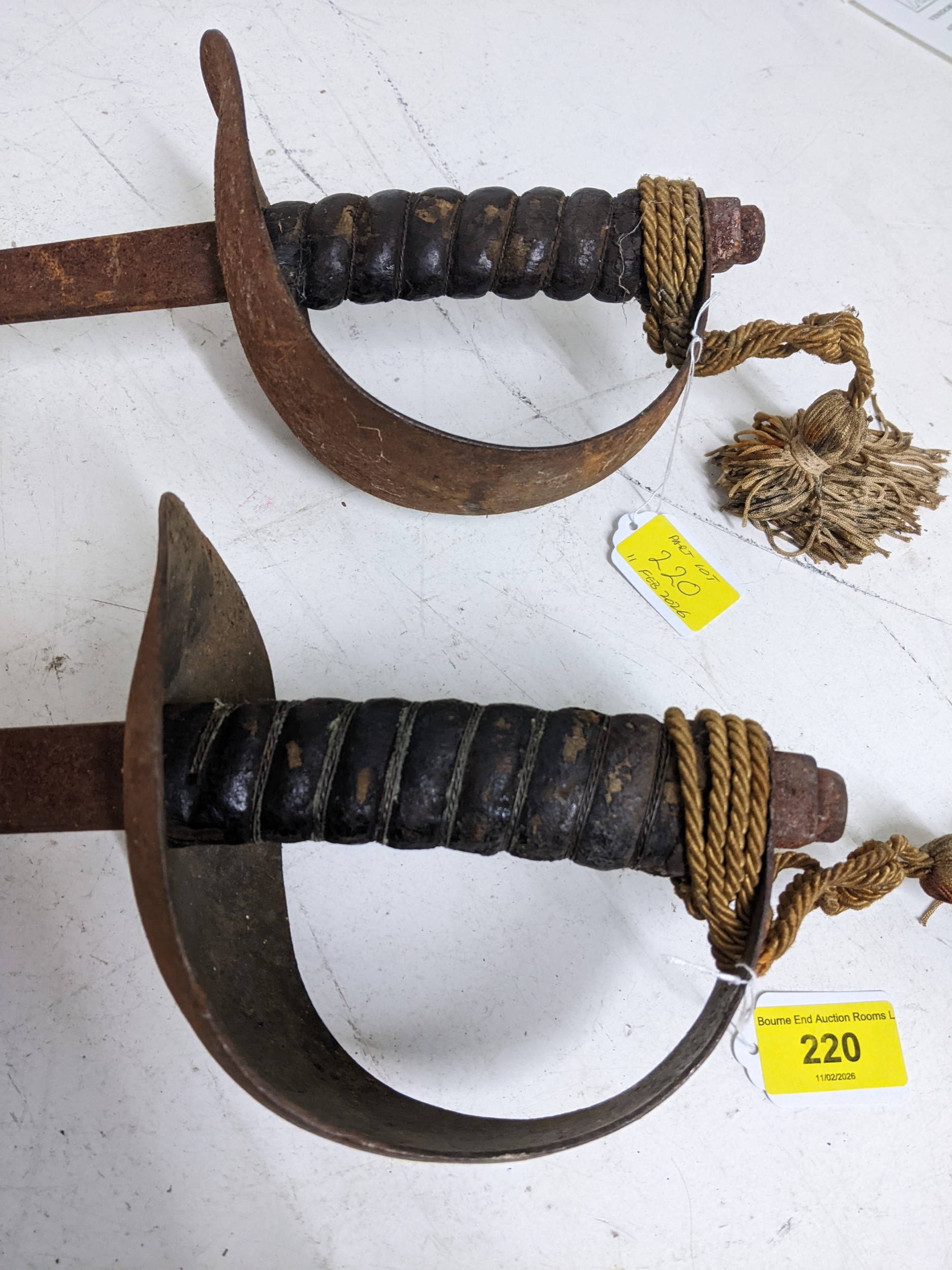 Two cutlass style swords with solid crossguards, leather bound and wore ...