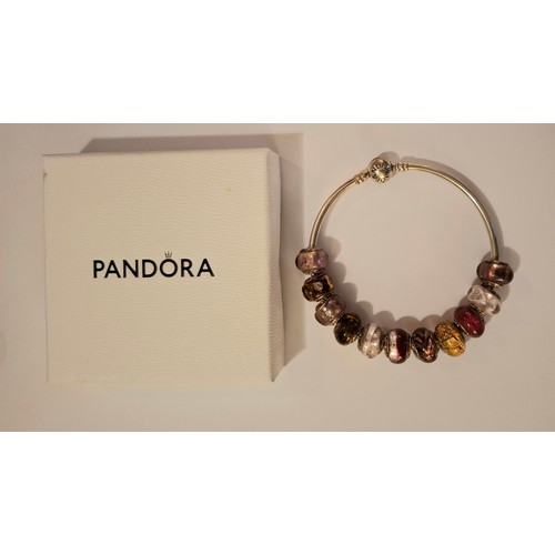 33 - Pandora & Lovebeads- A silver charm bracelet with 11 compatible (not Pandora) coloured glass bead ch... 