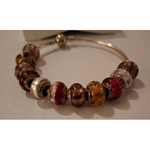 33 - Pandora & Lovebeads- A silver charm bracelet with 11 compatible (not Pandora) coloured glass bead ch... 