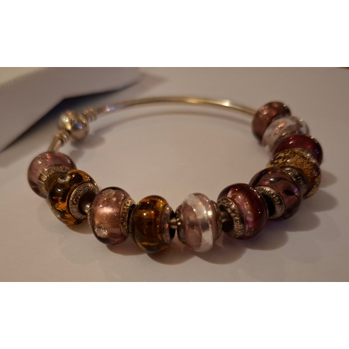 33 - Pandora & Lovebeads- A silver charm bracelet with 11 compatible (not Pandora) coloured glass bead ch... 