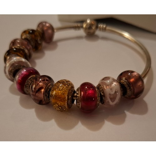 33 - Pandora & Lovebeads- A silver charm bracelet with 11 compatible (not Pandora) coloured glass bead ch... 