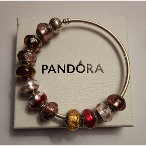33 - Pandora & Lovebeads- A silver charm bracelet with 11 compatible (not Pandora) coloured glass bead ch... 
