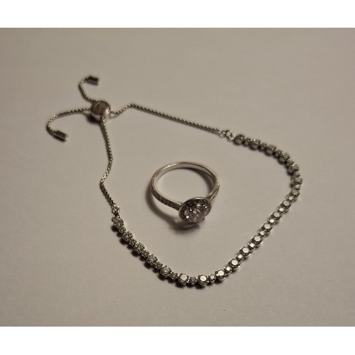 35 - Swarovski- A silver tone adjustable bracelet with 40 white crystals having a branded box and care bo... 