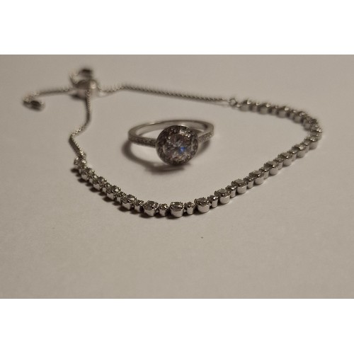 35 - Swarovski- A silver tone adjustable bracelet with 40 white crystals having a branded box and care bo... 