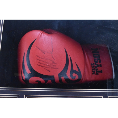 174 - Boxing Memorabilia: A boxing glove signed by Mike Tyson, set within a frame, bears certificate of Au... 