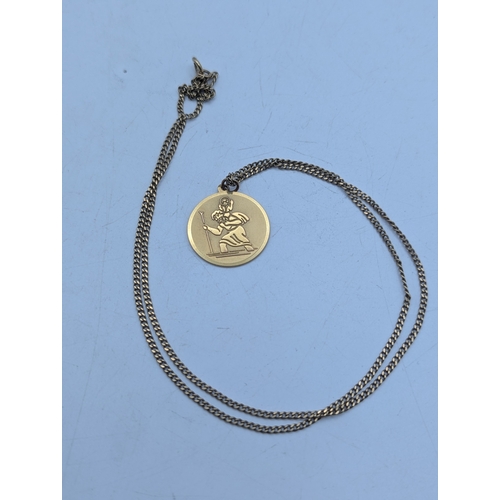 15 - A 9ct yellow gold St Christopher pendant 2cm diameter, on a 9ct gold flat curb link necklace with sp... 