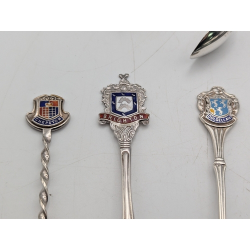 29 - Silver to include a pair of sugar tongs, a tablespoon and three collectors' spoons, total weight 145... 