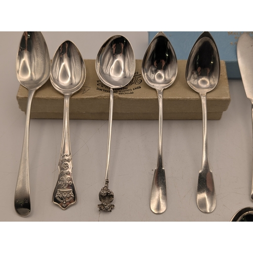 30 - An assortment of silver teaspoons some with engraved initials along with butter knives and other flo... 