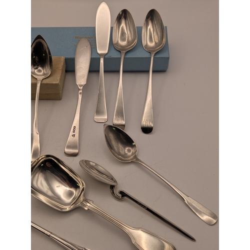30 - An assortment of silver teaspoons some with engraved initials along with butter knives and other flo... 