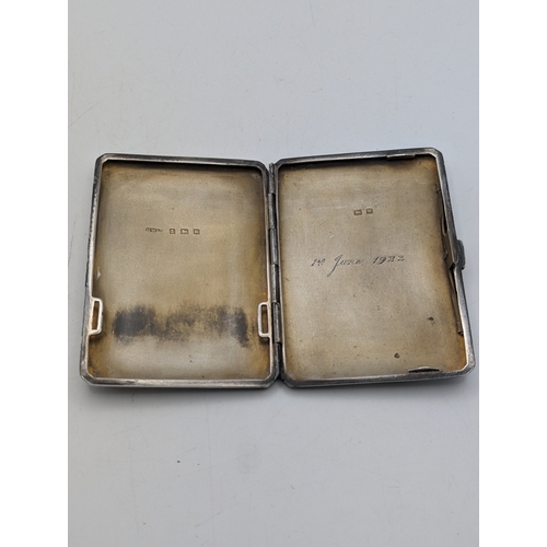 31 - A silver cigarette case with engine turned stripped pattern and central cartouche engraved with the ... 