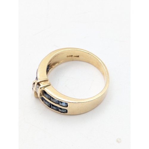 43 - A 14ct yellow gold ring with channel set sapphires and four bar set diamonds, size N1/2, weight 4.9g... 